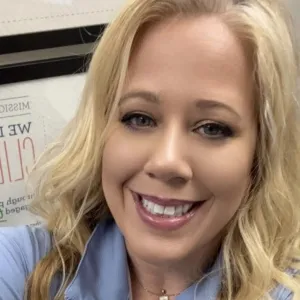 andrea is smiling wearing a blue shirt